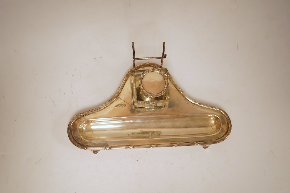 A George V silver inkstand, with single mounted glass well, pen rest and pen recess, with reeded ribbon border, William Hutton & Sons, Sheffield, 1913, 23.9cm, 5.2oz.